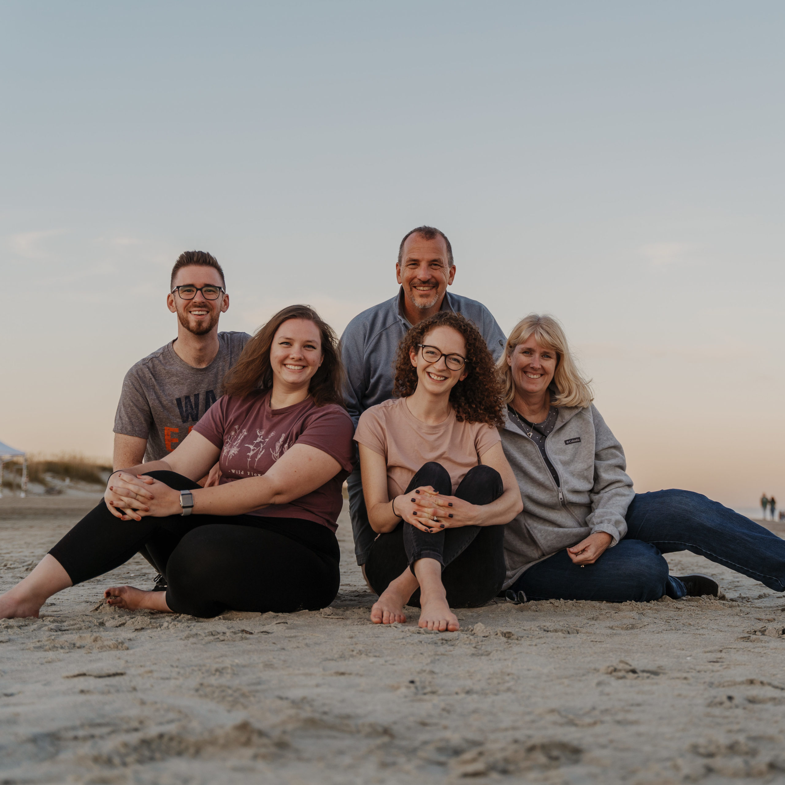Family of 5 poses for photo on beach